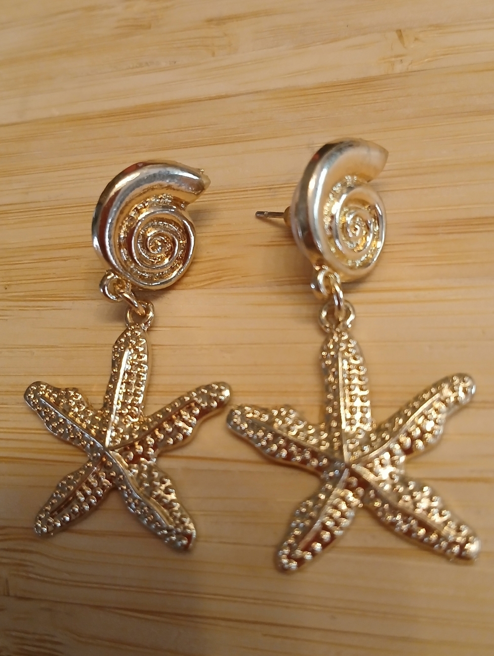 Textured gold-tone starfish drop earrings featuring a seashell stud 1.7"